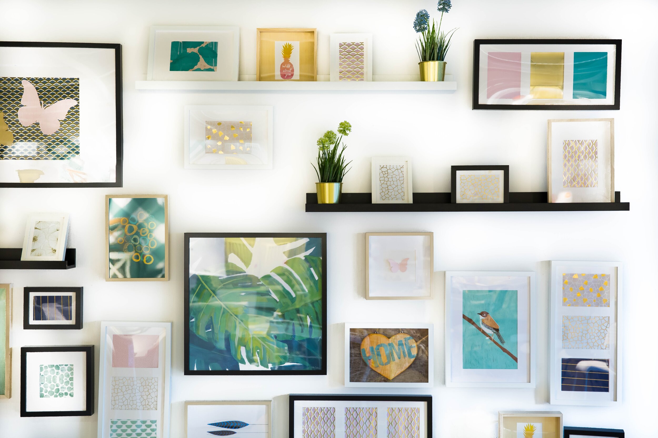 wall of paintings and frames